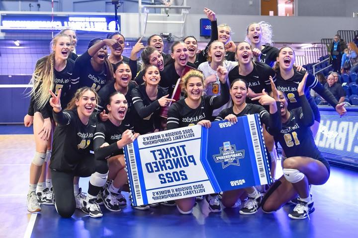 The Cal State LA Women's Volleyball team celebrating a victory.